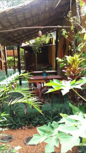 a patio with a wooden table and some plants at Pousada Vila Alter in Alter do Chao