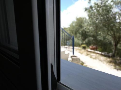 an open window with a view of a playground at Athani Summer House (Apartments 03 - 04) in Athanion
