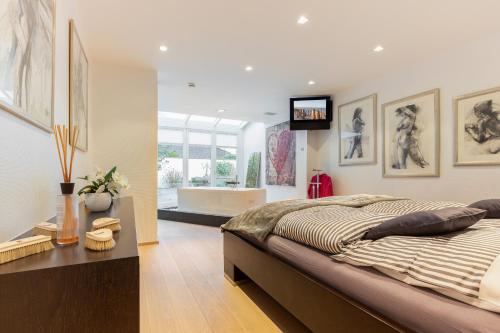 a bedroom with a large bed and a television on the wall at James Home in Kampen