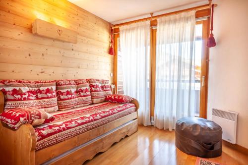 un salon avec un canapé et une fenêtre dans l'établissement PLOCHE 3, à Morzine