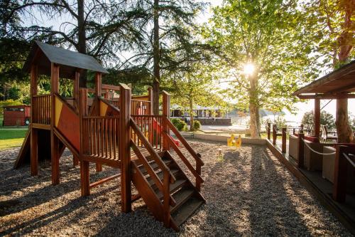 a playground with a slide in a park at Hotel Haliaetum - San Simon Resort in Izola
