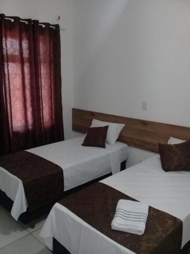 En eller flere senger på et rom på Porto Seguro Office Hotel