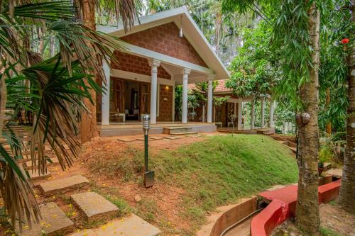 a house with a parking meter in front of it at Orchid Trails Resort in Sultan Bathery