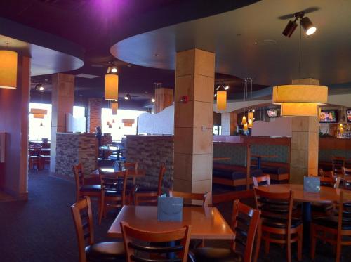 a dining room with wooden tables and chairs at Grand Harbor Resort and Waterpark in Dubuque