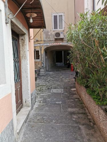 an alley way in a building with an archway at Apartment Niko in Piran