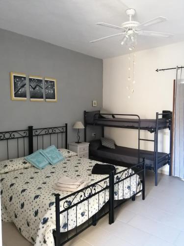 a bedroom with two bunk beds and a ceiling fan at Affittacamere D&D in Porto San Paolo