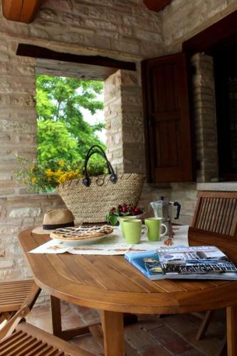 a wooden table with food and cups on it at Rustic Country House in Smirra
