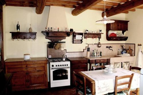 a kitchen with a stove and a table in it at Rustic Country House in Smirra
