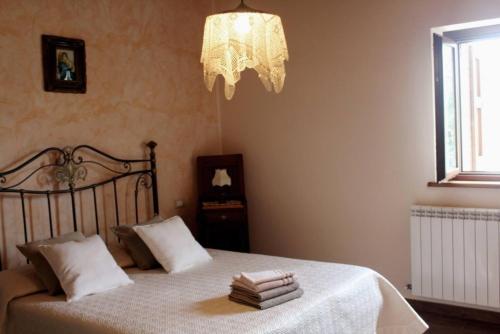 a bedroom with a bed with a chandelier at Rustic Country House in Smirra