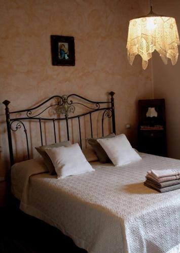 a bedroom with a large bed with white sheets and pillows at Rustic Country House in Smirra