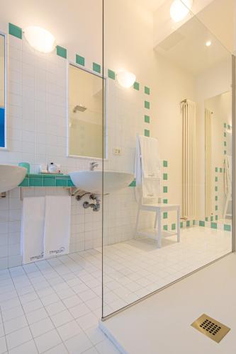 a bathroom with a glass shower and a sink at L'Angolo di Lore B&B in Fano