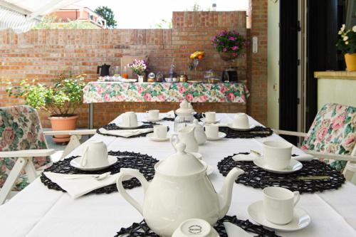 a table with a white tea set on it at L'Angolo di Lore B&B in Fano