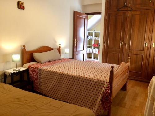 a bedroom with a bed and a dresser with two lamps at Templar Secrets House in Tomar