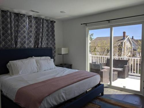 a bedroom with a bed and a sliding glass door at Lux 3 Bd - Perfect & Parking & Massive Patio in Ventnor City