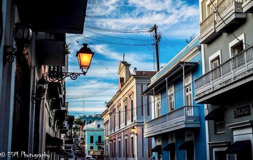 a city street with buildings and a street light at Navona Studios in San Juan