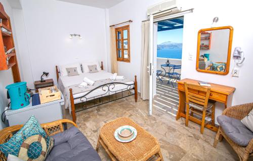 a living room with a bed and a table at Stelios Rooms in Oia