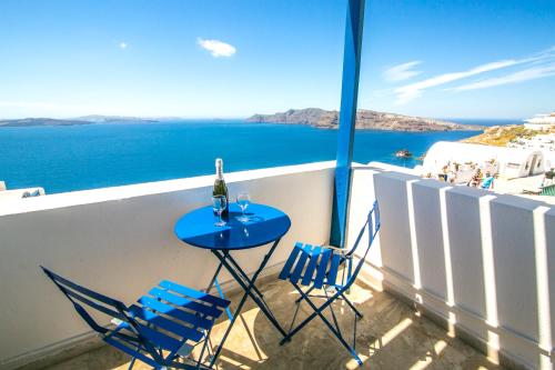 a blue chair sitting on top of a wooden table at Stelios Rooms in Oia