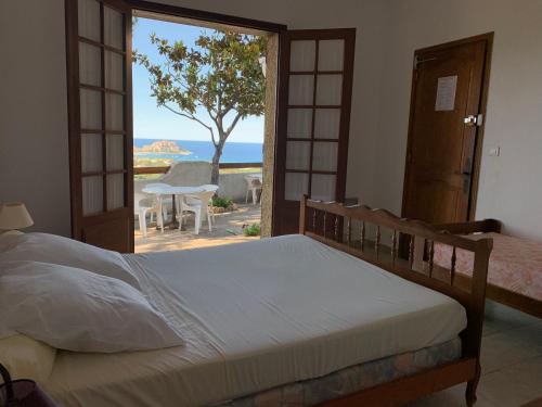 a bedroom with a bed and a view of the ocean at Relais International de la Jeunesse in Calvi