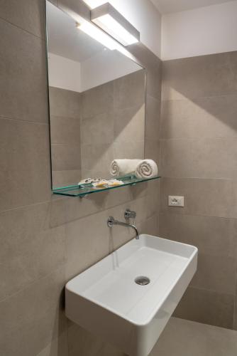 a bathroom with a white sink and a mirror at Residence Marinella in San Vito lo Capo