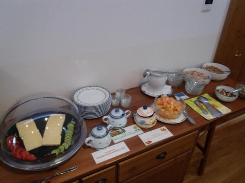a table with plates and bowls of food on it at Gasthof zur Kirche in Kottes