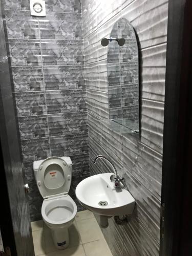 a bathroom with a toilet and a sink at Appartement meublé sécurisé in Agadir
