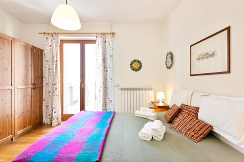 a bedroom with a large bed and a large window at Flat in the heart of Pisa in Pisa