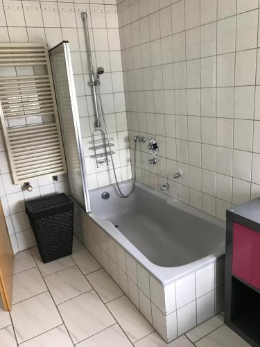 a bath tub in a bathroom with a mirror at Fewo-Seither in Wilnsdorf