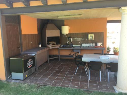 a kitchen with a table and chairs and a counter at El cerro de cabañeros in Retuerta de Bullaque