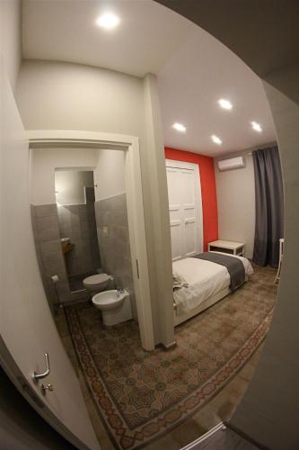 a hotel room with a bed and a toilet at B&B Terre di Catania in Catania