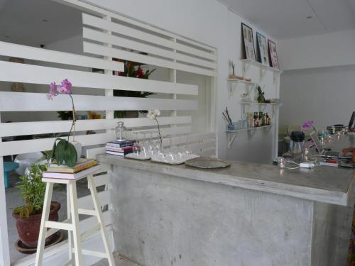 a kitchen with a counter with glasses on it at La Pari-Pari in Pantai Cenang