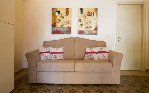 a couch in a living room with two pillows on it at Cà di Rò in Polignano a Mare