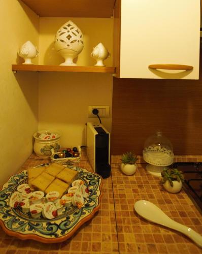 a kitchen with a counter top with a plate on the floor at Cà di Rò in Polignano a Mare