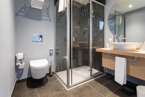 a bathroom with a shower and a toilet and a sink at Stay Hotel Coimbra Centro in Coimbra