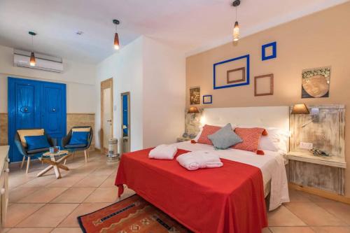 a bedroom with a bed with a red blanket at Kikka B&B in Tarxien