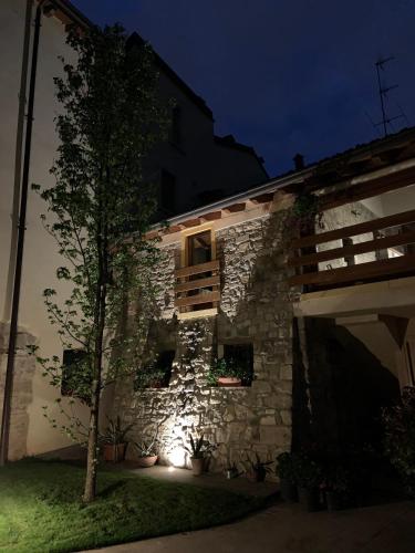 a stone building with a tree in front of it at Da Agostino, la casa del latte in Costa di Mezzate