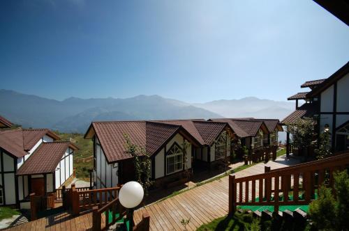 a row of houses with mountains in the background at Sea of Clouds Vacation Villa in Renai