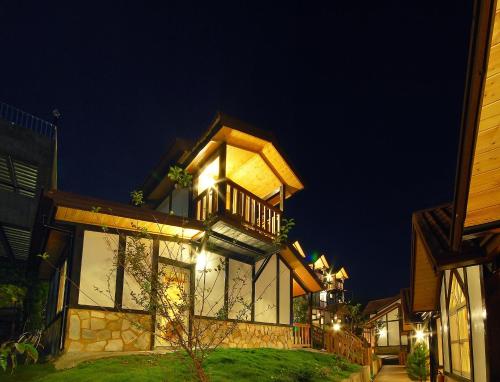 a large building with a balcony at night at Sea of Clouds Vacation Villa in Renai