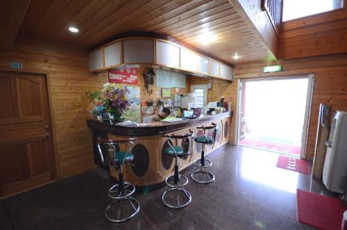 a kitchen with a bar in the middle of a room at Sea of Clouds Vacation Villa in Renai