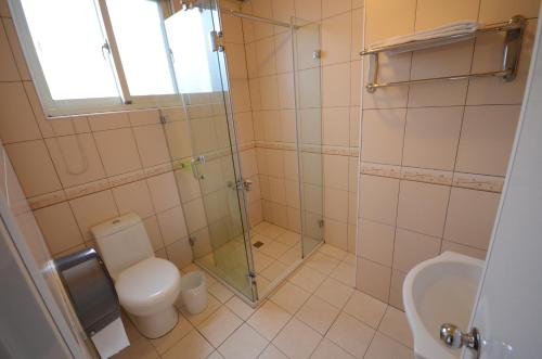 a bathroom with a toilet and a glass shower at Sea of Clouds Vacation Villa in Renai
