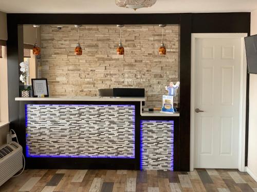 a bar in a room with a brick wall at Days Inn by Wyndham Orange in Orange