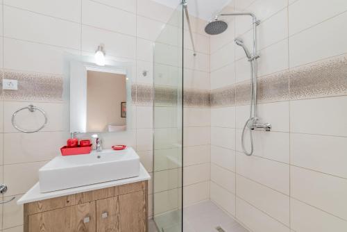 bagno bianco con lavandino e doccia di Sea La Vie Villa a Città di Zante