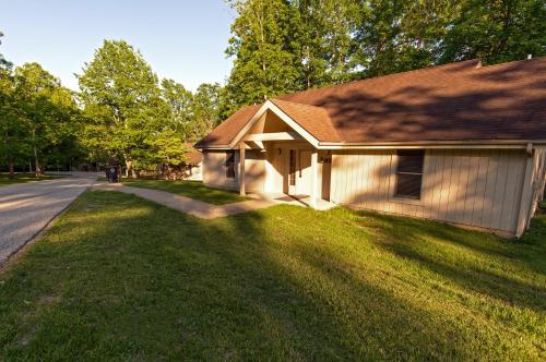 a house on the side of a road next to a yard at Carter Caves State Resort Park in Olive Hill