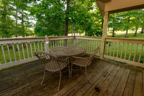 a table and chairs sitting on a deck at Carter Caves State Resort Park in Olive Hill