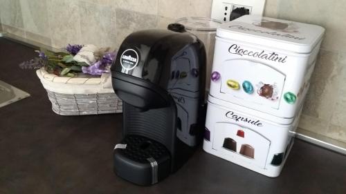 a black appliance sitting on a counter next to a microwave at Carpe Diem Ancona in Ancona