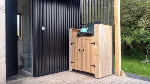 a wooden locker sitting on a wooden deck at Nire Valley Eco Camp in Ballymacarbry
