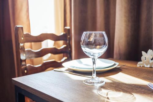 a wine glass sitting on top of a table at Memory House in Kutaisi