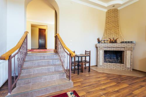 a staircase in a home with a fireplace at Memory House in Kutaisi