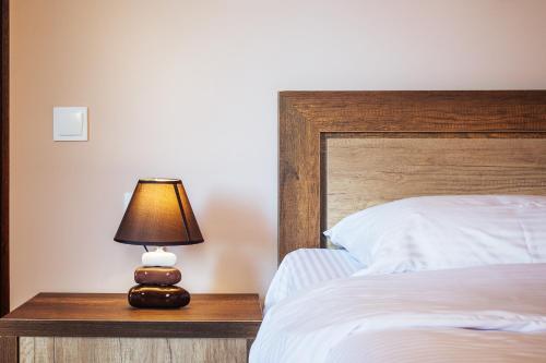 a lamp sitting on a table next to a bed at Memory House in Kutaisi