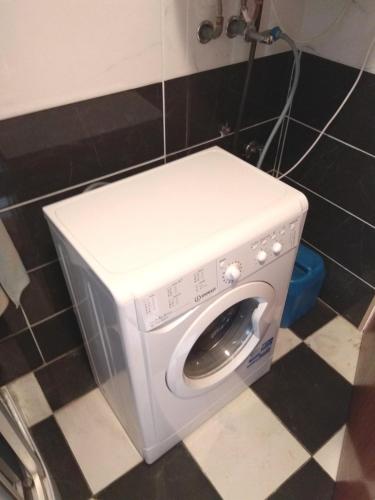 a white washing machine in a bathroom with at Koppi Ház in Siófok