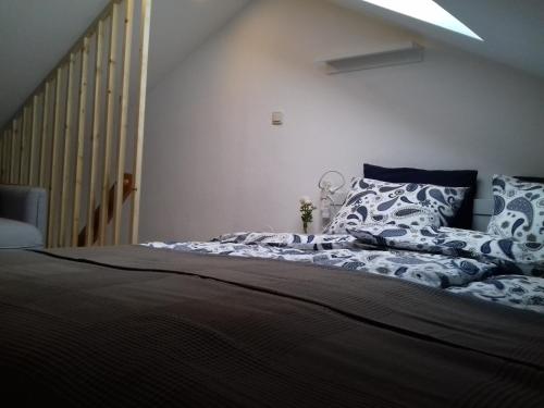 a bedroom with a large bed with blue and white pillows at Ferienwohnung Wiesmühlstrasse in Henndorf am Wallersee